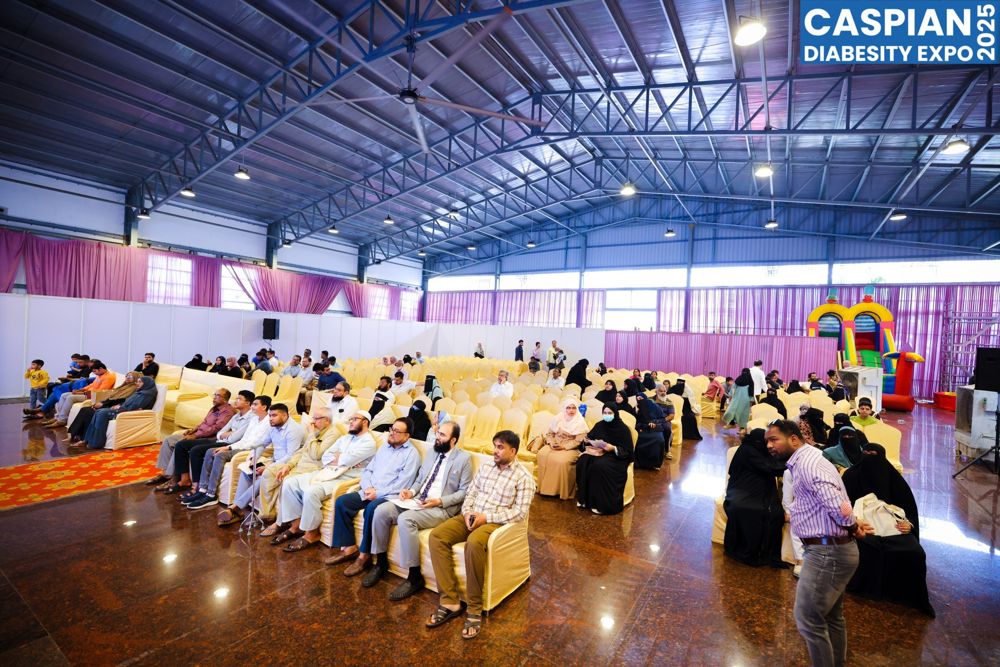 The packed expo hall with families and a kids play zone