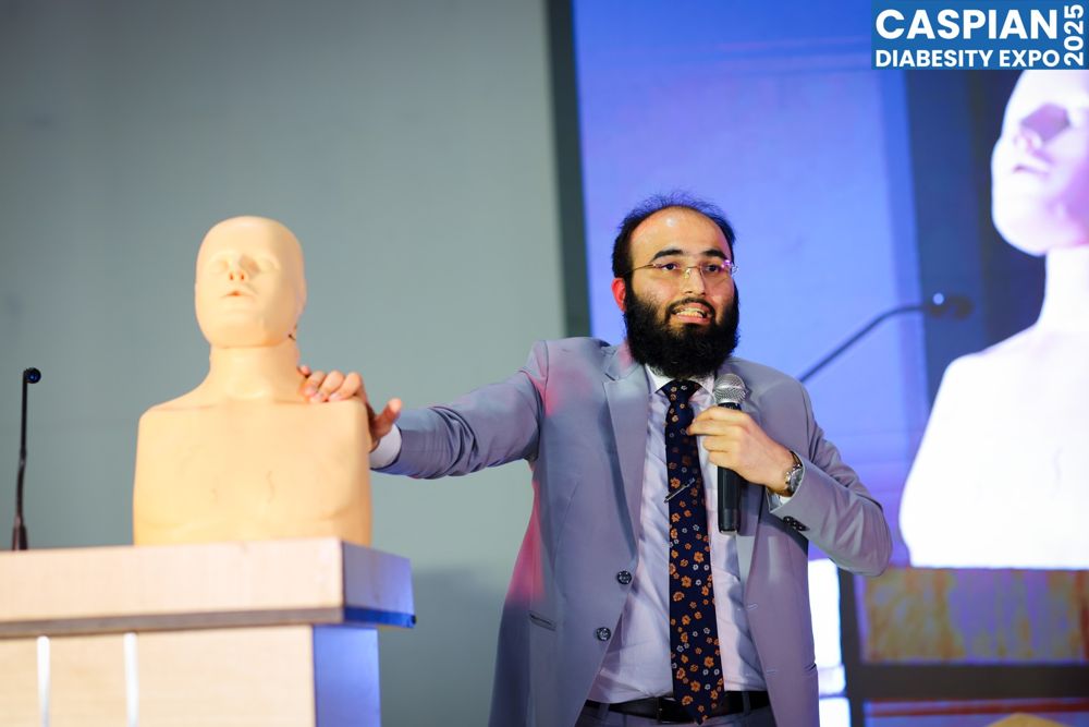 CPR demonstration with a manikin on stage