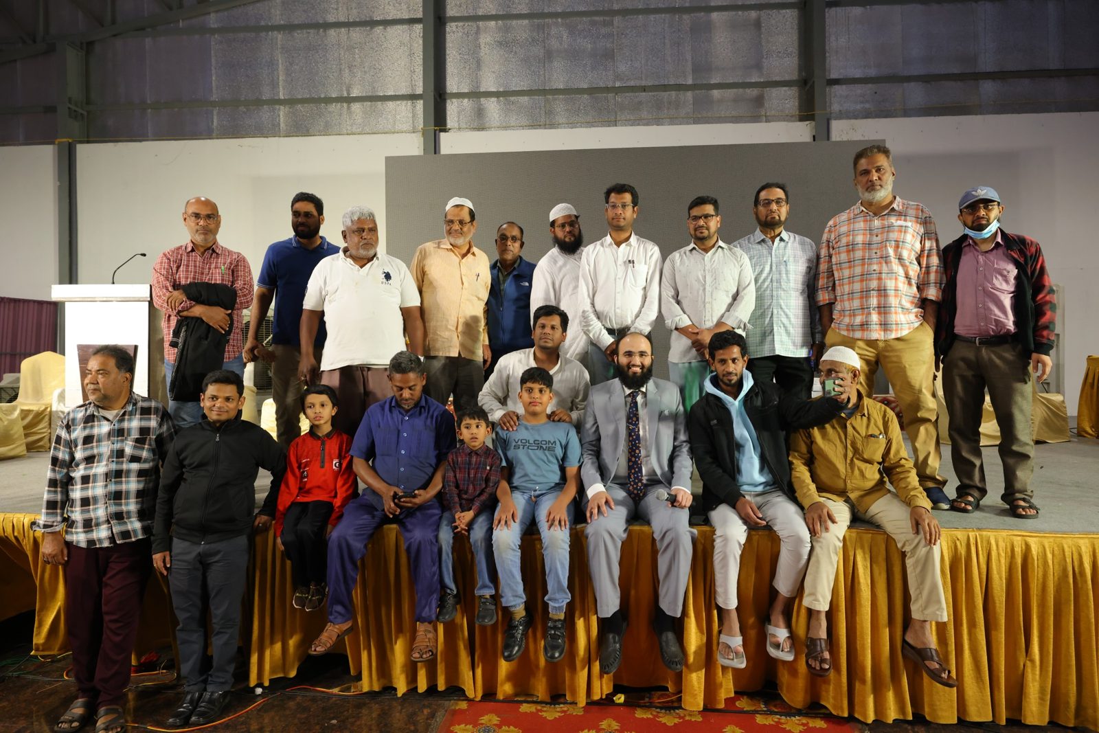 Community members and children on stage