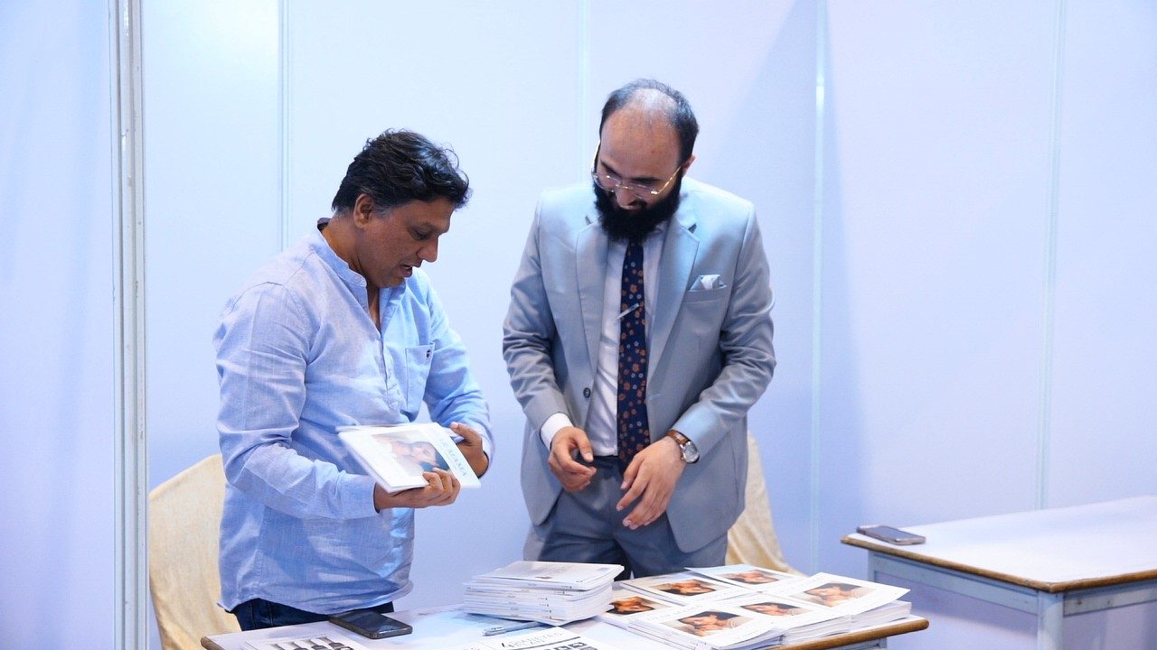 Dr Khizer with visitors at a stall
